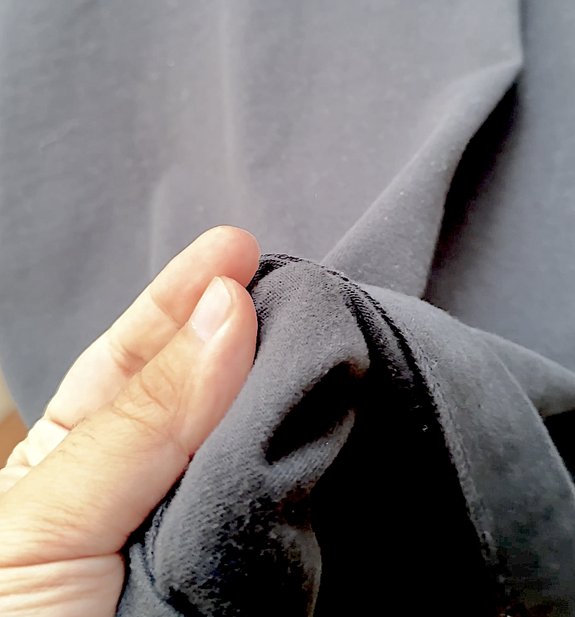 Hand pinching the soft heavyweight cotton fabric