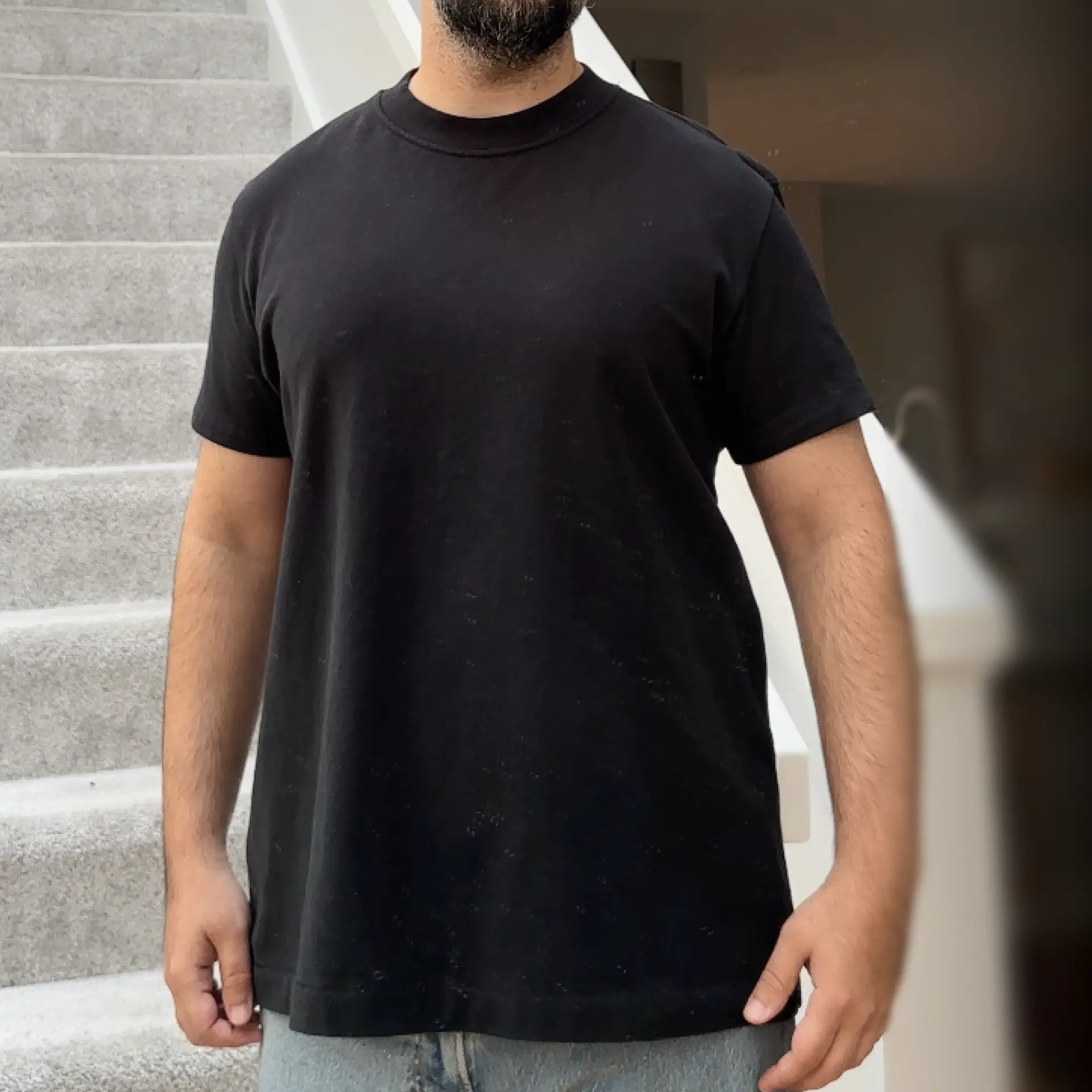 Man wearing the Delmade T-shirt, front view